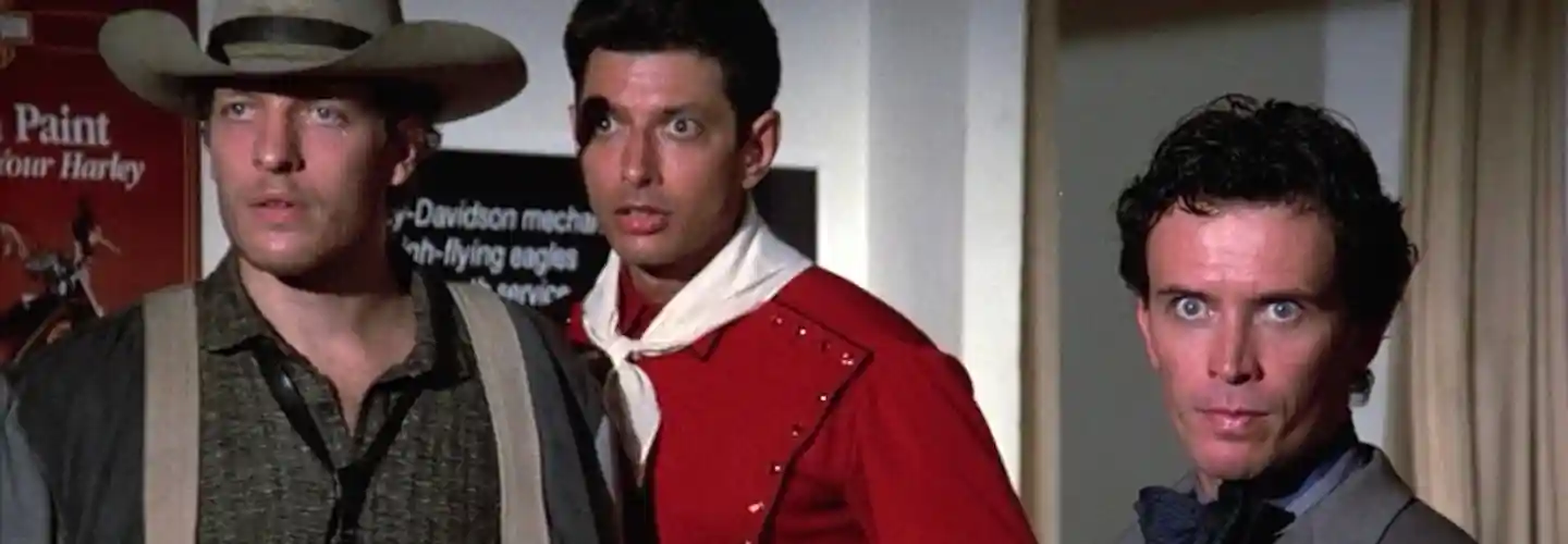 Dr. Buckaroo Banzai (Peter Weller), New Jersey (Jeff Goldblum), and Rawhide (Clancy Brown) come upon the nefarious Dr. Emilio Lizardo (John Lithgow) in The Adventures of Buckaroo Banzai Across the 8th Dimension (1984)